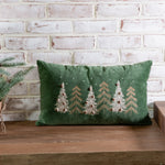 Green velvet lumbar pillow with a row of embroidered pine trees