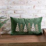 Green velvet lumbar pillow with a row of embroidered pine trees