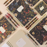 Spiral-bound art journal with a Forest Flowers illustrated cover, detail view