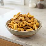 A variety of spicy snack foods including corn sticks, sesame sticks, and peanuts seasoned with southwestern spices.