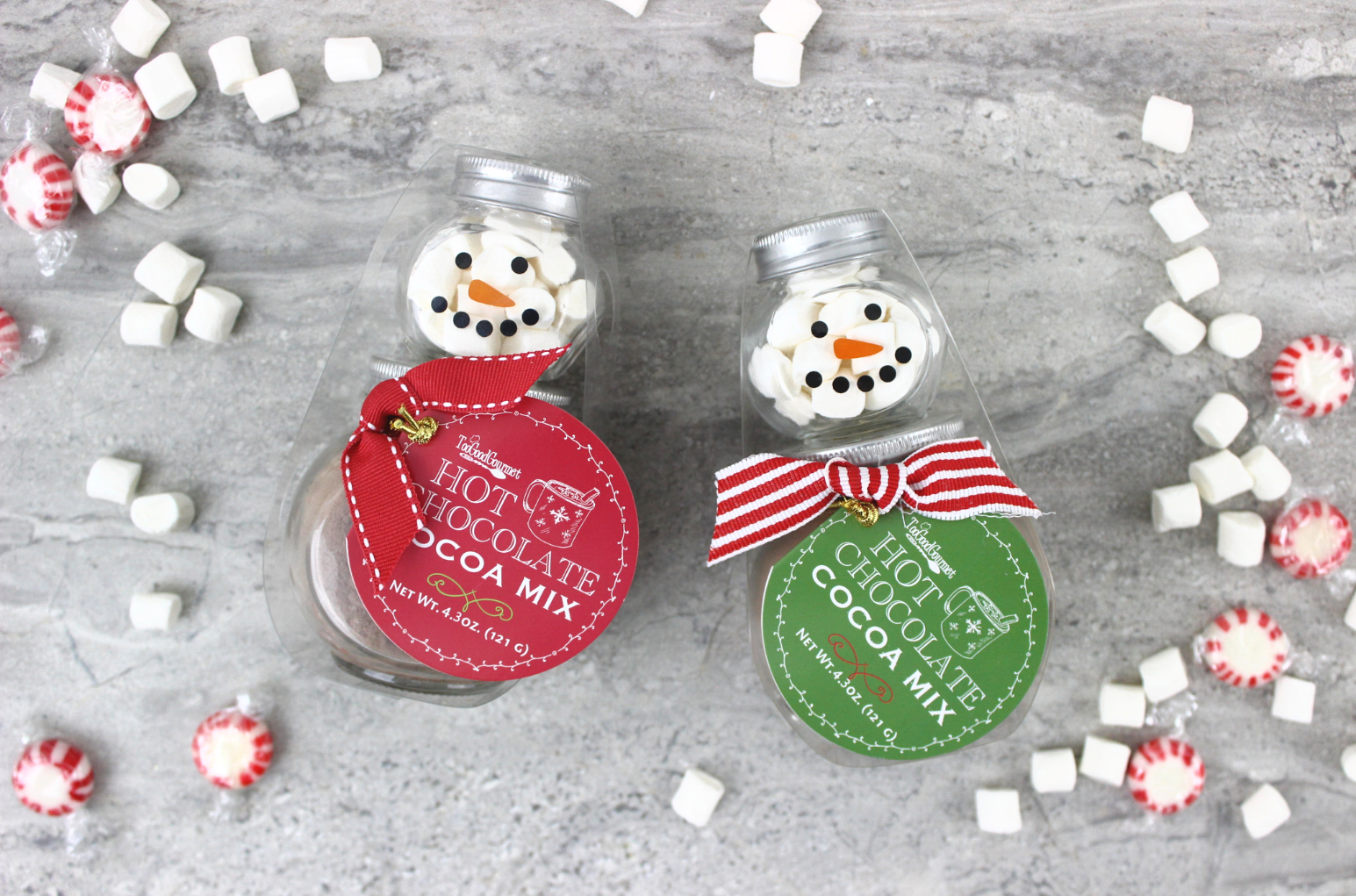 Mini snowman hot cocoa jars styled with marshmallows and peppermints