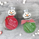 Mini snowman hot cocoa jars styled with marshmallows and peppermints