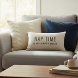 Beige pillow with text 'Nap time is my happy hour' on a white background