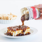 Hot Pepper Bacon Jam poured over cream cheese with crackers