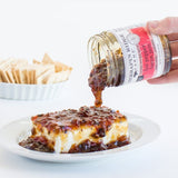Hot Pepper Bacon Jam poured over cream cheese with crackers