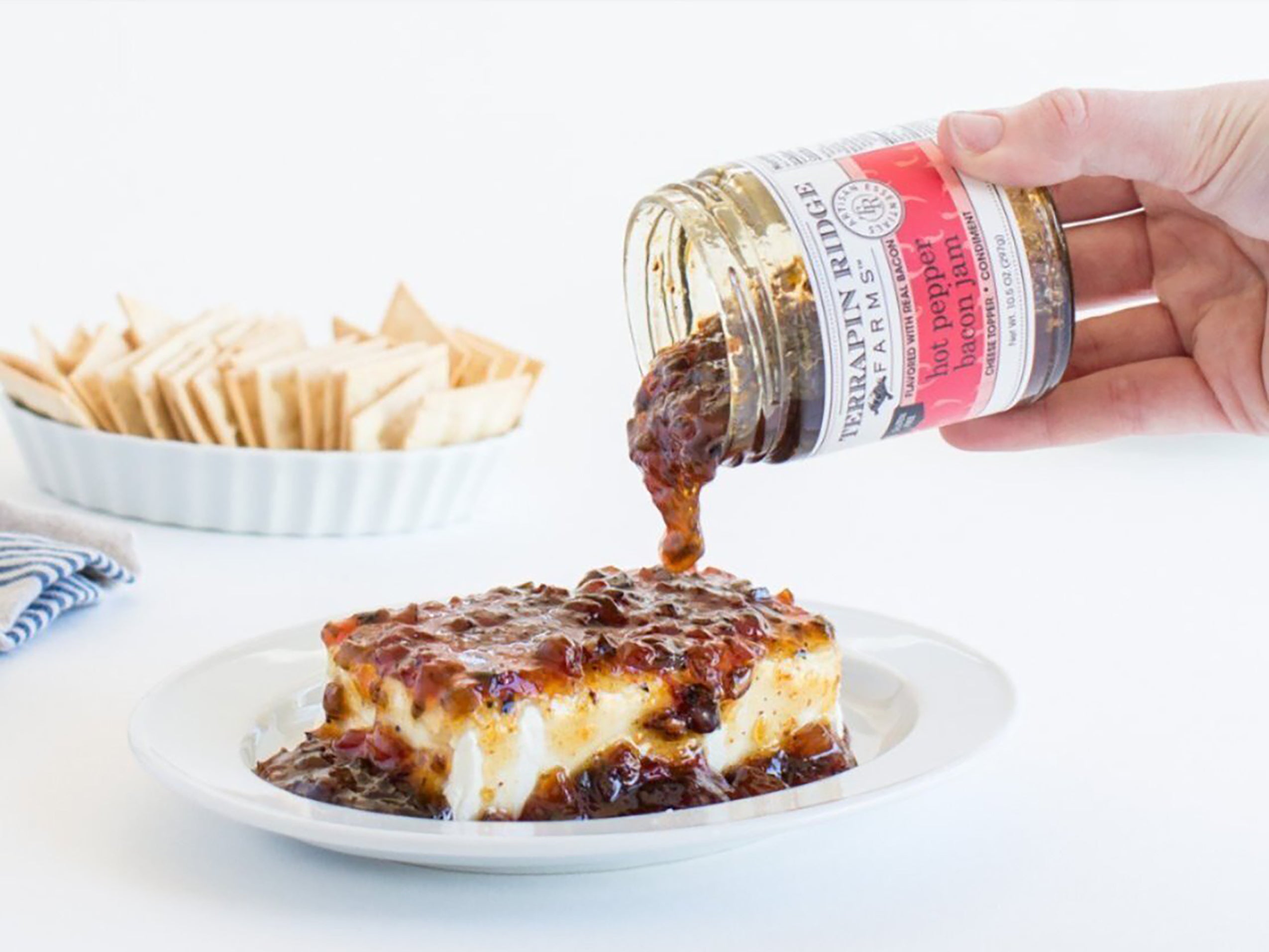 Hot Pepper Bacon Jam poured over cream cheese with crackers