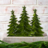 Tall trio of glossy green wood trees with star tops