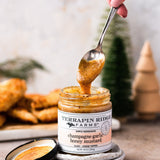 Spoon dipping into Champagne Garlic Honey Mustard with fried appetizers