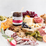 Hot Pepper Bacon Jam on a charcuterie board with meats, cheeses and crackers