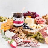 Hot Pepper Bacon Jam on a charcuterie board with meats, cheeses and crackers