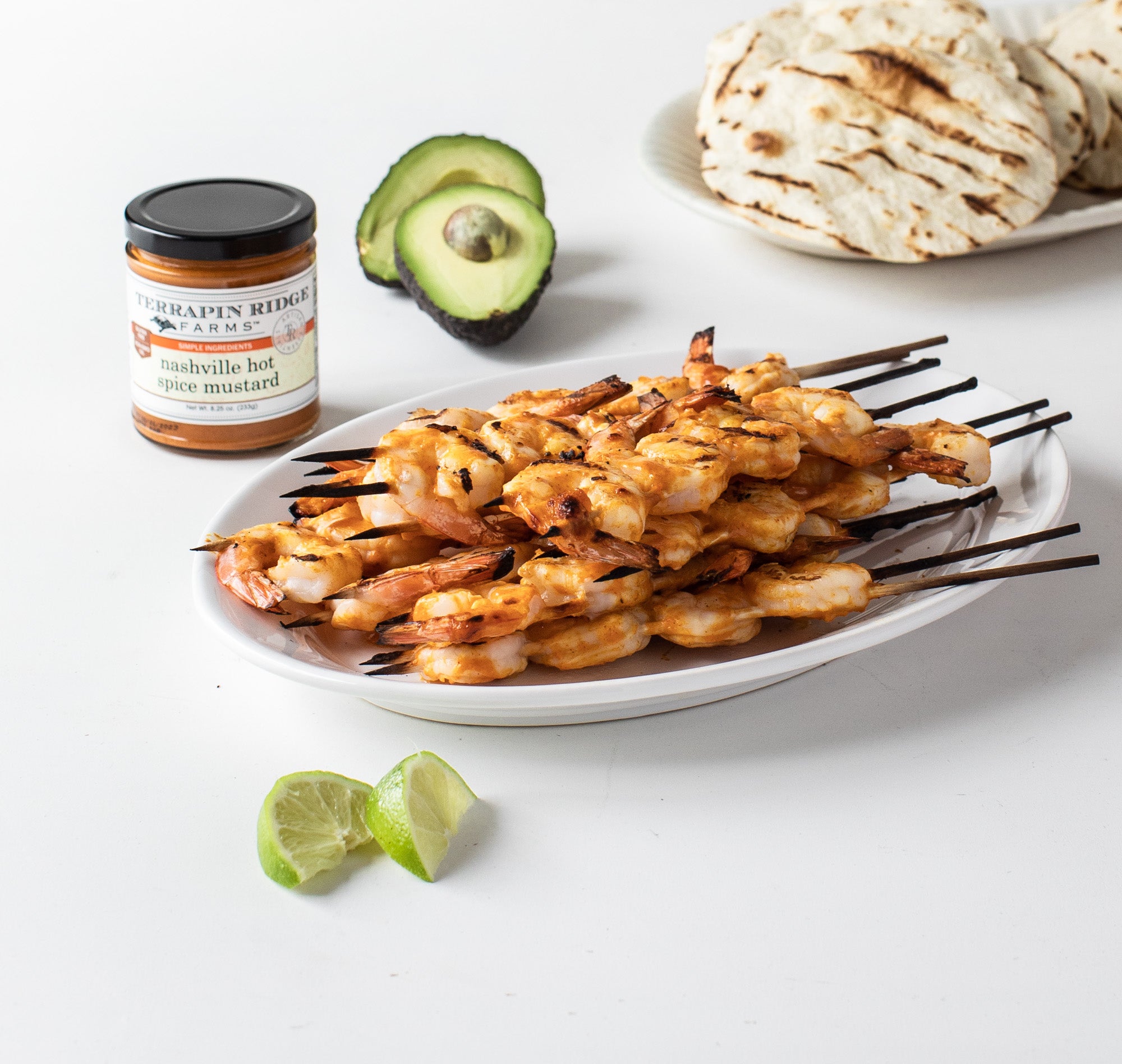 Grilled shrimp skewers with lime, avocado and Nashville Hot Mustard