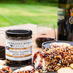 Goat cheese topped with Blueberry Bourbon Pecan Jam and pecans, served with crackers