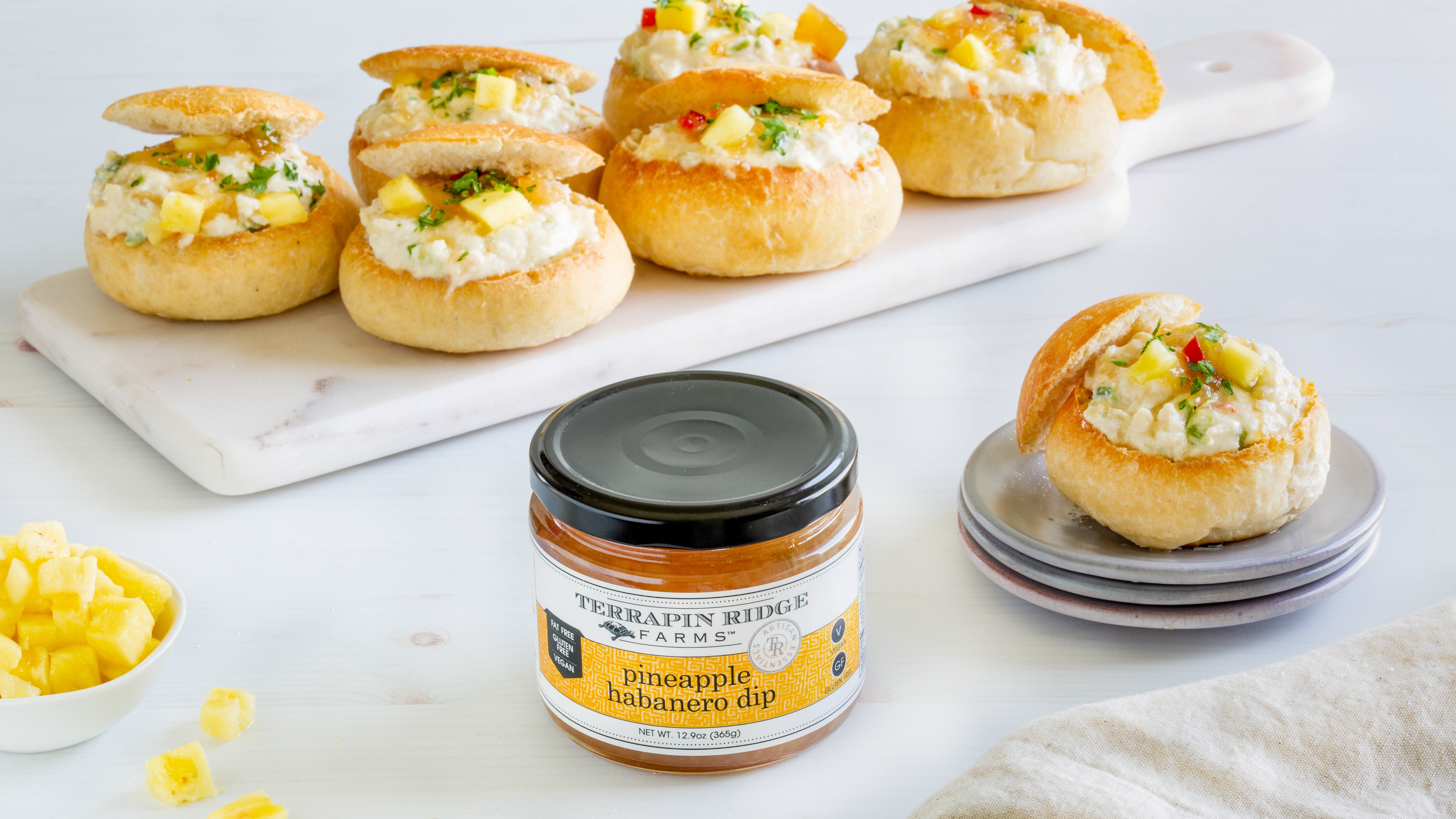 Mini bread bowls filled with pineapple habanero dip