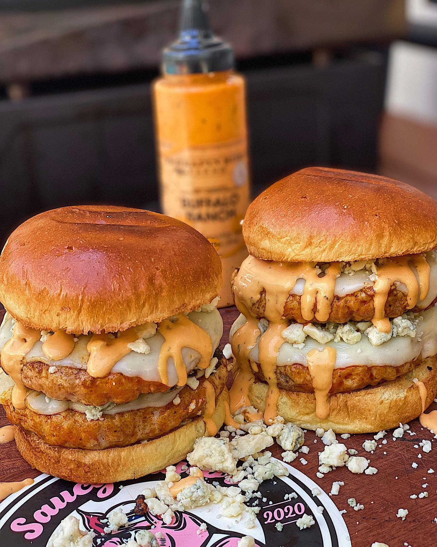 Stacked chicken burgers with melted cheese and Buffalo Ranch sauce