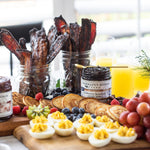 Breakfast board with pancakes, bacon, fruit and Blueberry Bourbon Pecan Jam