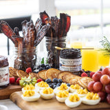 Breakfast board with pancakes, bacon, fruit and Blueberry Bourbon Pecan Jam