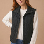 High Neck Snap Button Quilted Puffer Vest in Black - styled front view