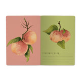 A5 ruled notebook with a painted peach and foliage cover design, detail view
