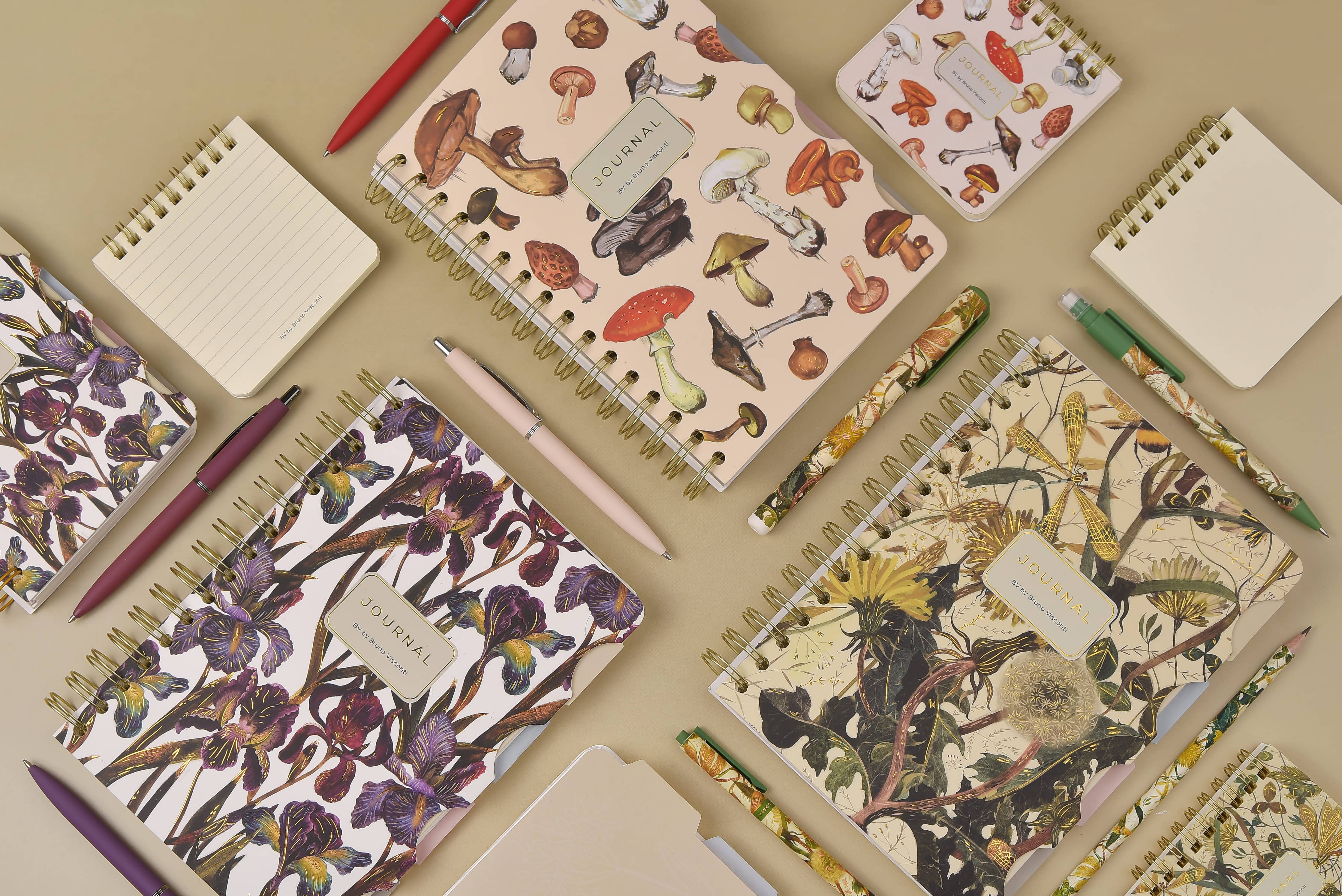 Spiral-bound art journal with a painted iris cover, interior pages