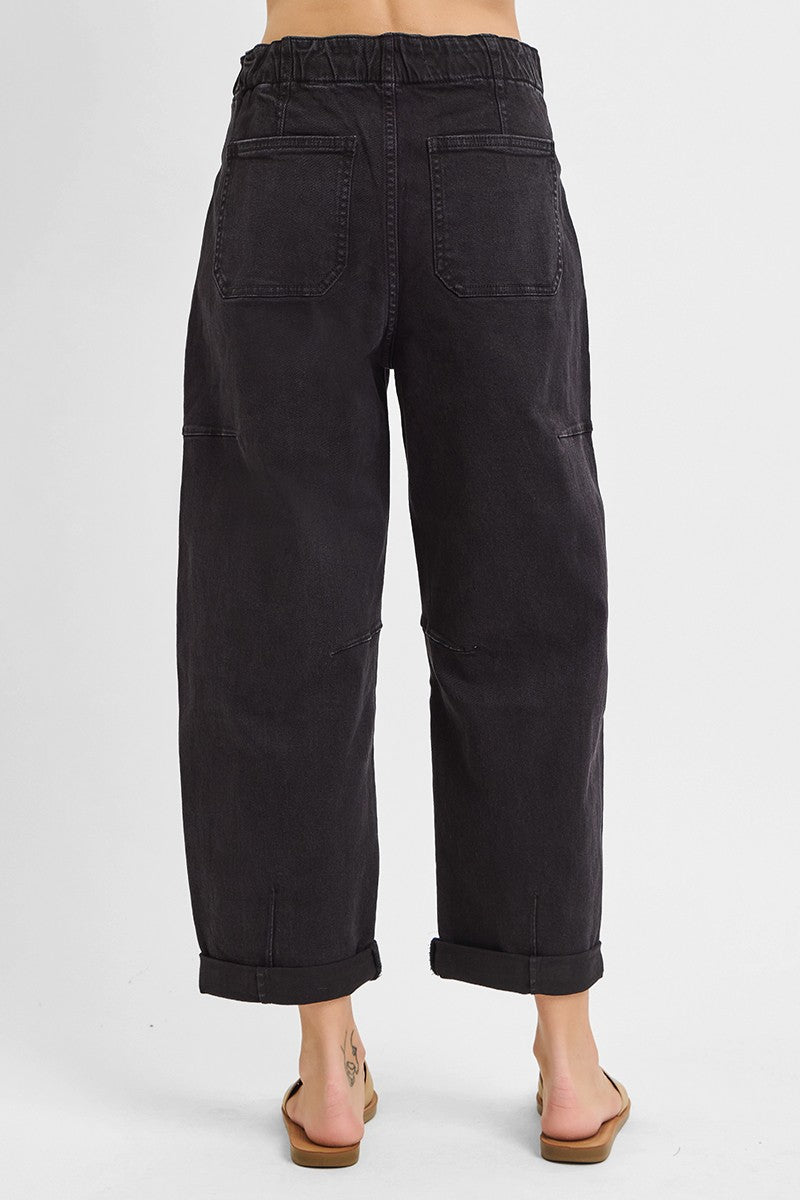 Side view of high rise cropped cargo jeans in black denim