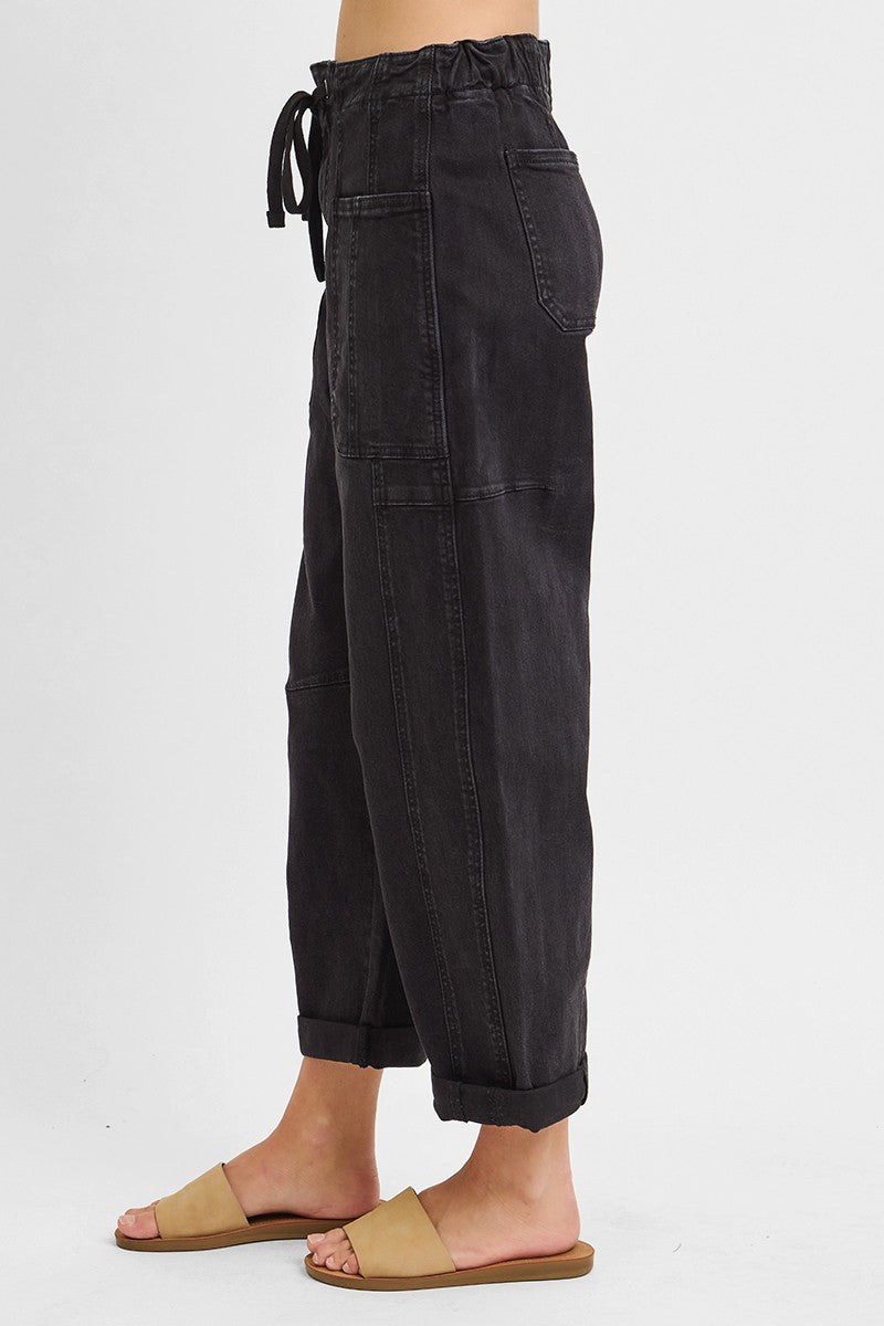 Cropped hem detail on black high rise barrel leg jeans