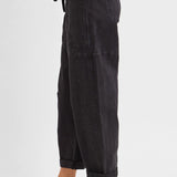 Cropped hem detail on black high rise barrel leg jeans