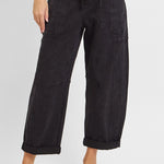 Black barrel leg cargo jeans styled with a simple top, full length view