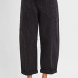 Black barrel leg cargo jeans showing curved thigh and tapered cropped hem