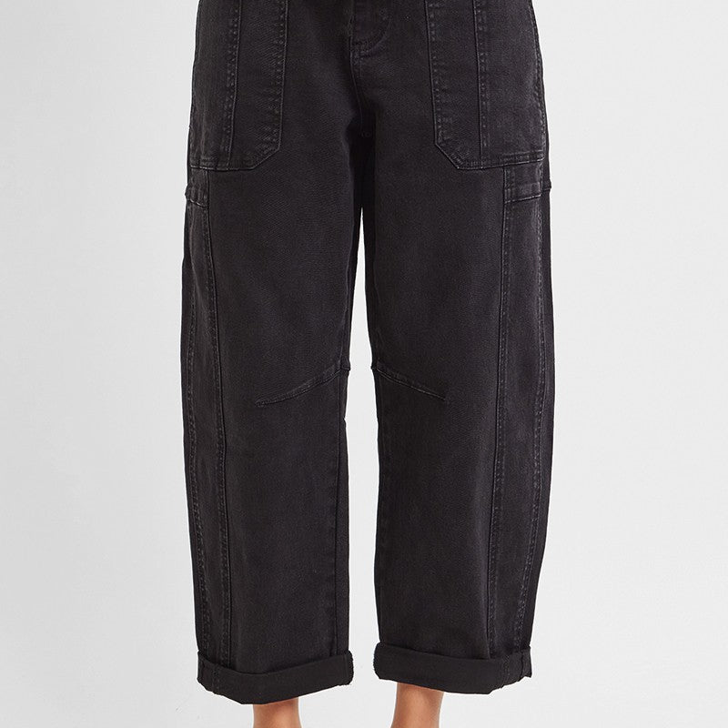 Black barrel leg cargo jeans showing curved thigh and tapered cropped hem