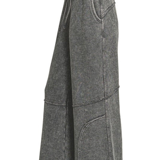 Side view of washed French terry flare pant showing wide leg and raw hem