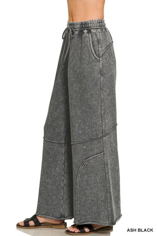 Side view of washed French terry flare pant showing wide leg and raw hem