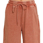 Close view of drawstring elastic waistband and side pocket on flare pant