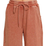 Close view of drawstring elastic waistband and side pocket on flare pant