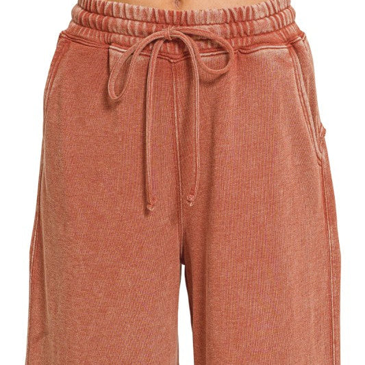 Close view of drawstring elastic waistband and side pocket on flare pant
