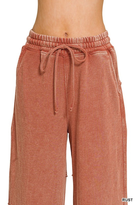 Close view of drawstring elastic waistband and side pocket on flare pant