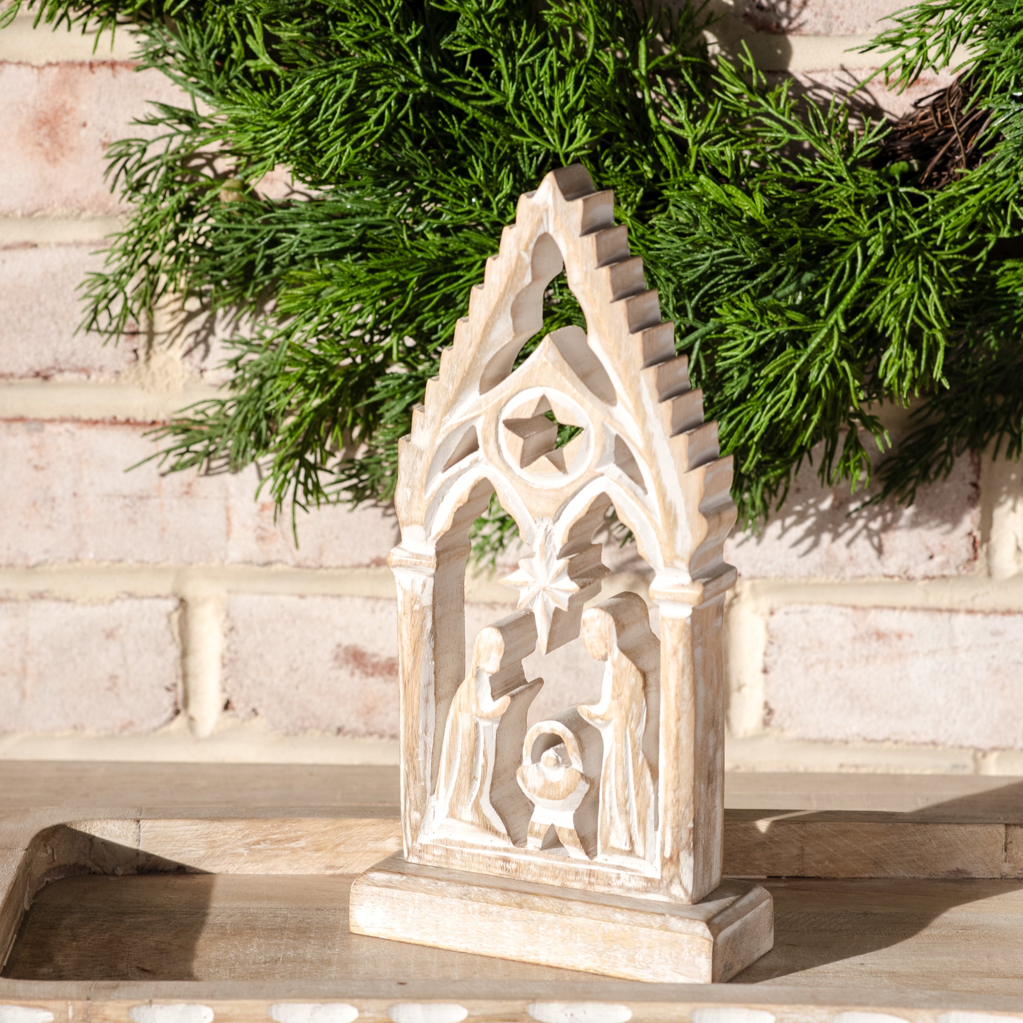 Whitewashed wooden arch nativity with Holy Family cutout