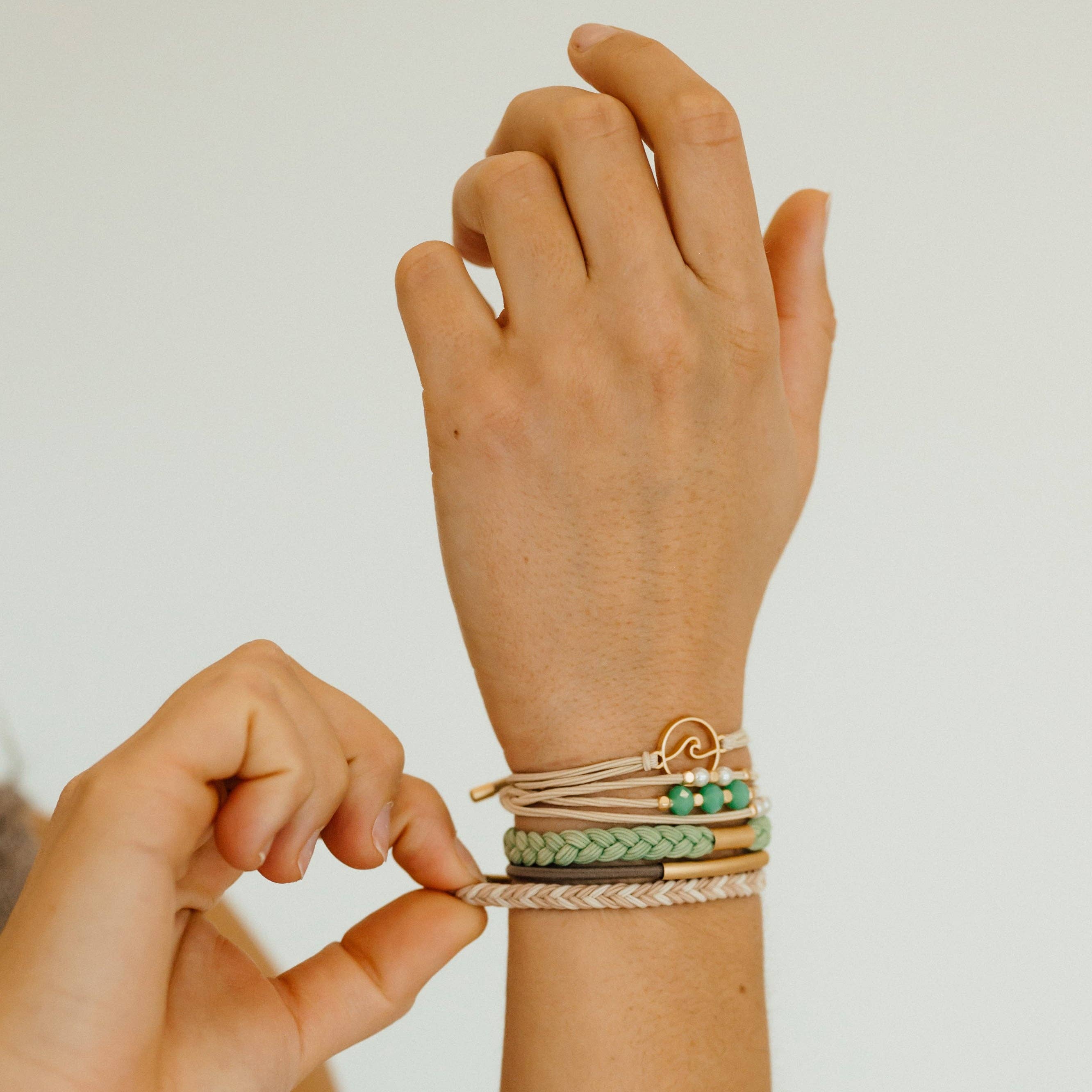 Reflect hair tie bracelet set in beachy neutrals and green with gold wave charm, view 6