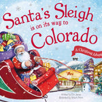 Book cover with Santa in a red sleigh full of gifts flying over a snowy Colorado town