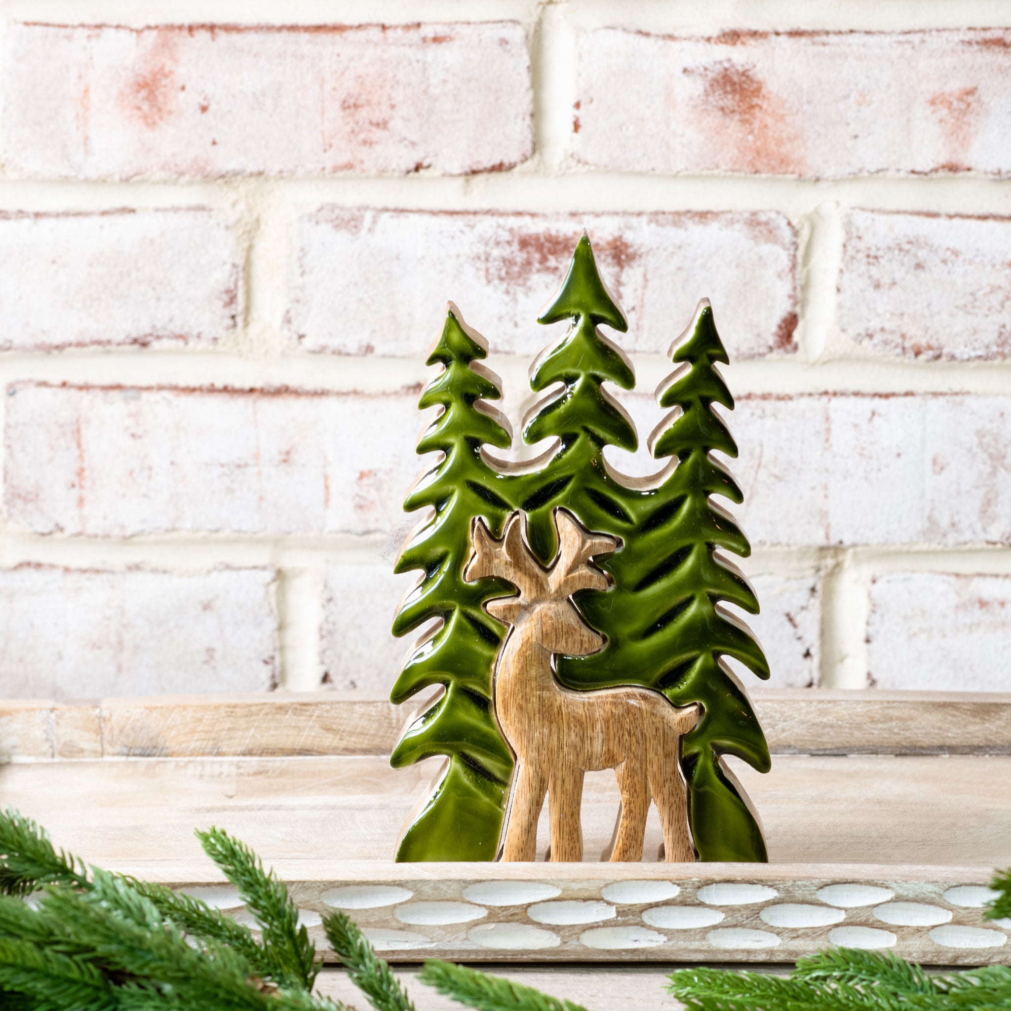 Green wood trees with a natural wood deer in front