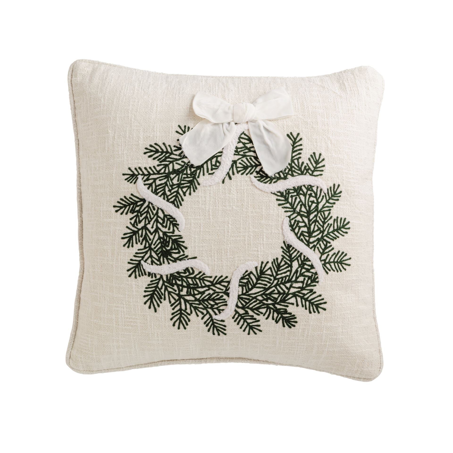 Square cream pillow with a green crewel-embroidered evergreen wreath and white bow
