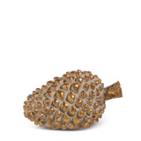 Large gold resin pinecone with deep overlapping scales, lying on its side