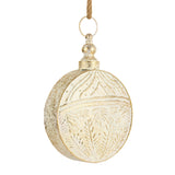 Round ivory bell with an embossed gold-brushed pattern hanging from a jute loop