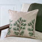 Oatmeal pillow embroidered with green pine sprigs