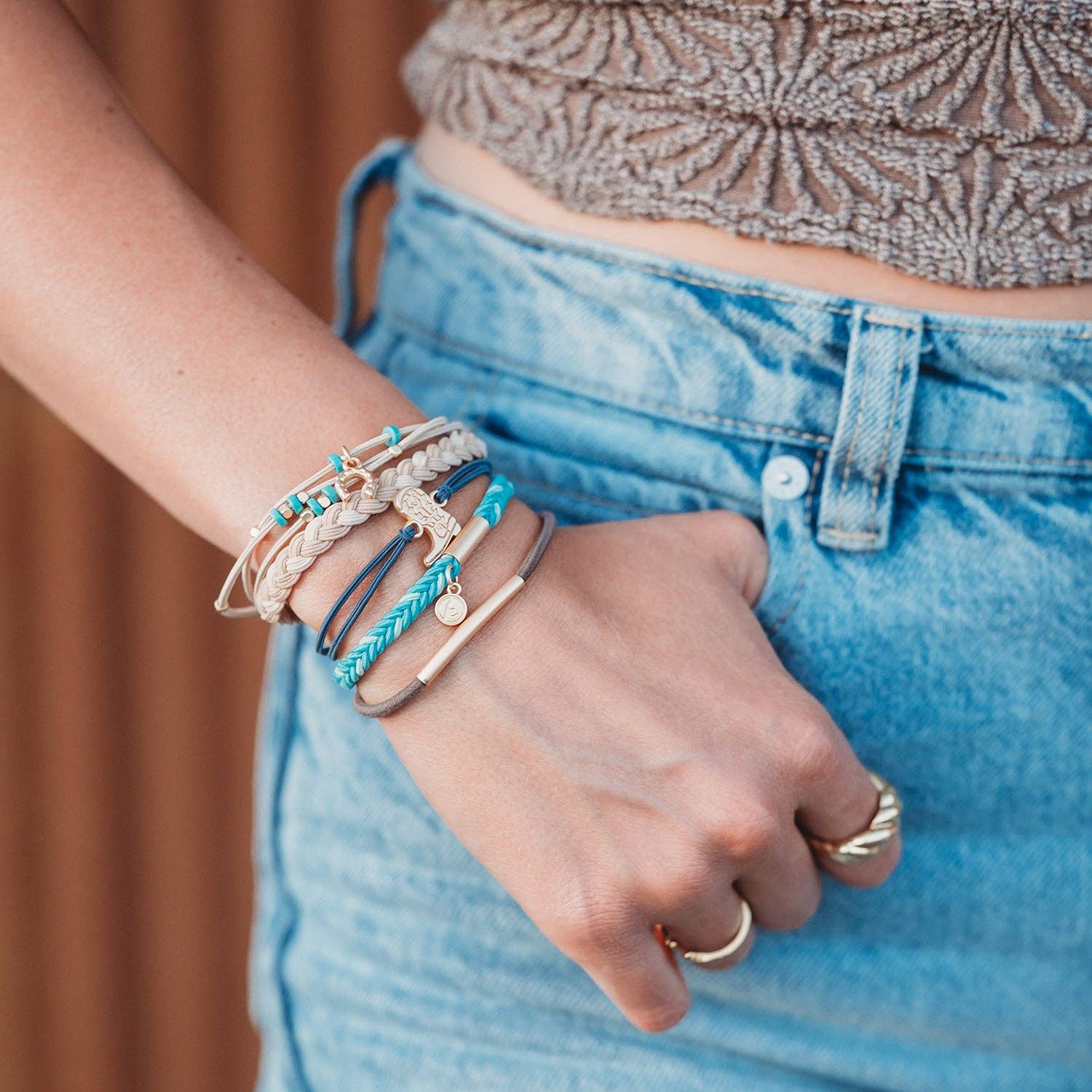 Stride hair tie bracelet set in blue, brown, cream and teal with gold cowboy boot and horseshoe charms, view 2