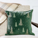 Deep green pillow embroidered with small evergreen trees and stars