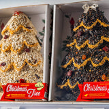 Two boxed seed trees with red Christmas Tree labels, side by side