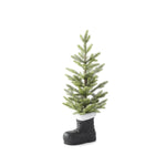 Flocked pine tree in a black boot with a fluffy white cuff, seen from a slight angle