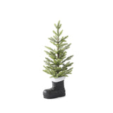 Flocked pine tree in a black boot with a fluffy white cuff, seen from a slight angle