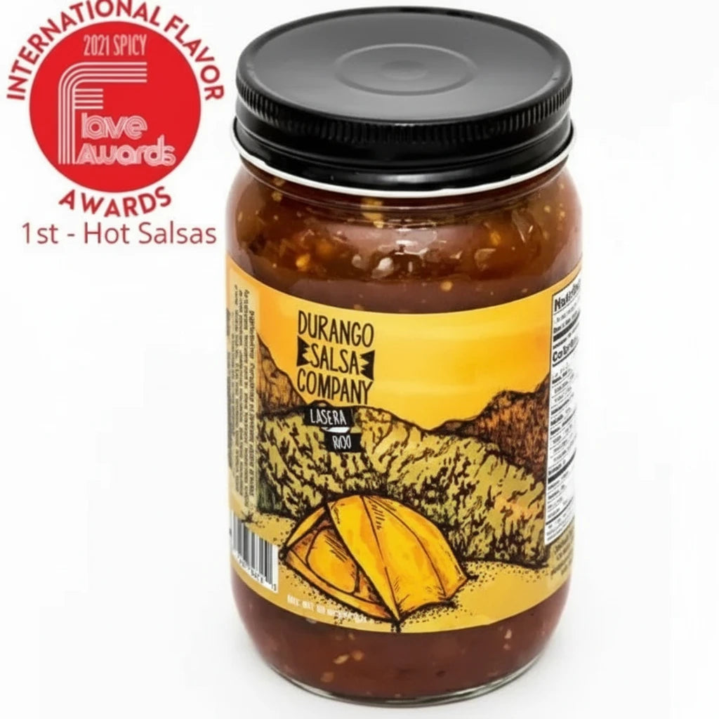 A jar of Durango Salsa Company Casera Salsa with a label featuring a tent in front of a mountain range. The salsa is awarded with a red badge stating '1st at Love Awards' and it is marked as a hot salsa.