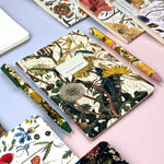 A5 ruled notebook with a green botanical cover design, interior ruled pages